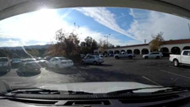 OJAI CALIFORNIA-2019: View Out Windshield Of Parked Vehicle With Traffic In Distance