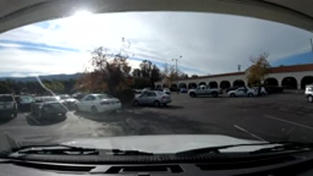 OJAI CALIFORNIA-2019: Parking Lot People Car Clouds Lines Time Passing On Clear