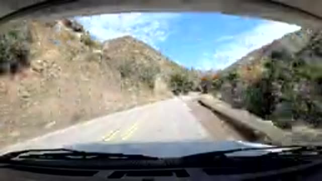 OJAI CALIFORNIA-2019: Vehicle Moves Down Winding Mountain Road Goes Through A Tunnel