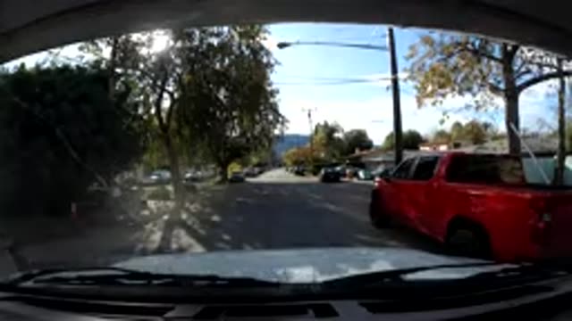 OJAI CALIFORNIA-2019: A Car Driving Down A Neighborhood Street With Pedestrians
