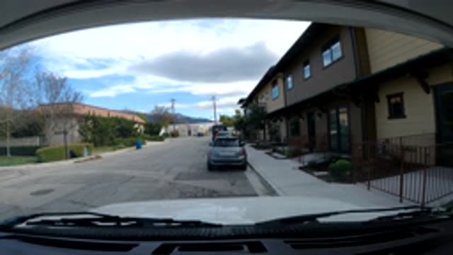 OJAI CALIFORNIA-2019: Car-Mounted Camera Overlooking Neighborhood Street With Garbage Truck