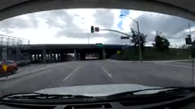 MALIBU CALIFORNIA-2019: Highway Moderate Traffic Trees Sky Clouds Small Hills