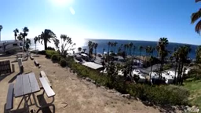 MALIBU CALIFORNIA-2019: Two Persons Sitting At A Bench Where One Is Having His Papers