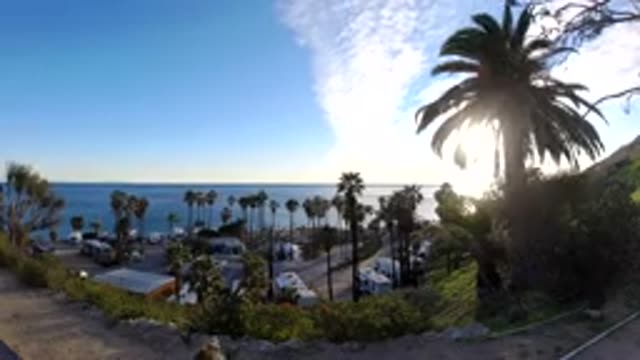 MALIBU CALIFORNIA-2019: A Time Lapse Of A Beach Side View With Palm Trees And