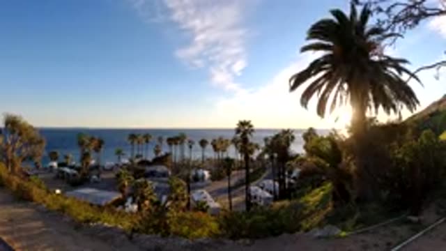 MALIBU CALIFORNIA-2019: The Beach With Trees And Sand And Sky And Sun