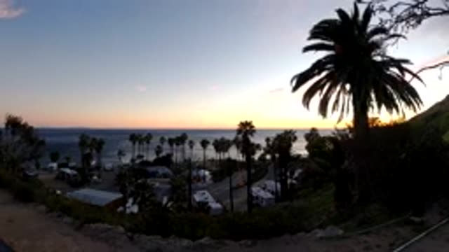 MALIBU CALIFORNIA-2019: Time Lapse Of A Beachside With Palm Trees And Sun