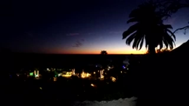 MALIBU CALIFORNIA-2019: Time Lapse Of Tropical City With Setting Sun And Moving Traffic