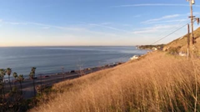 MALIBU CALIFORNIA-2019: Seaside Grass Hills Showing Ocean And Palm Trees