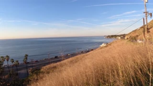 MALIBU CALIFORNIA-2019: Blue Ocean Water And Tall Tan Grass On A Sunny Day