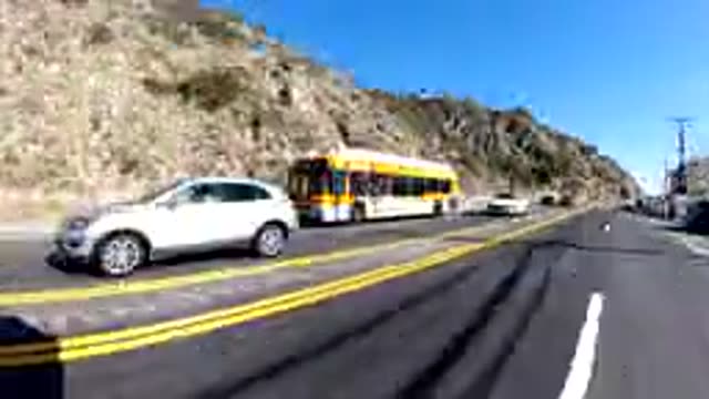 MALIBU CALIFORNIA-2019: Car Zooming Down A Four Lane Highway With Lots Of Other Cars