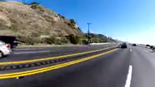 MALIBU CALIFORNIA-2019: Car Going Down The Road And Stopping On Traffic
