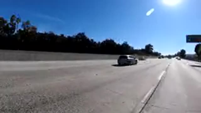 MALIBU CALIFORNIA-2019: Vehicle Moves Down Divided Highway Film Seeded Up Road
