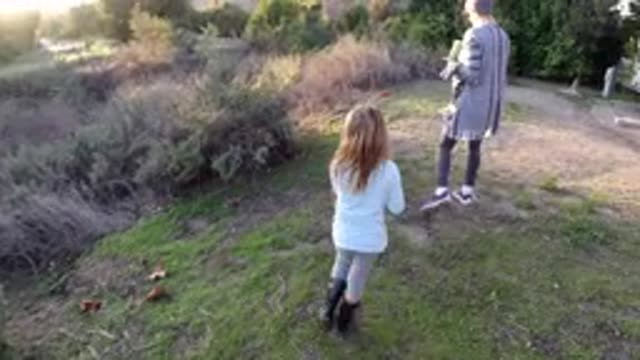 SAN CLEMENTE CALIFORNIA-2019: Little Girl Follows Her Pet Dog Walking On The