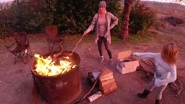 SAN CLEMENTE CALIFORNIA-2019: Woman Teaches Marshmallow Roasting Technique To Daughter