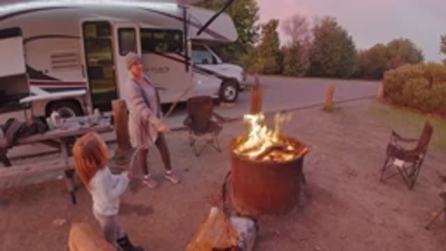 SAN CLEMENTE CALIFORNIA-2019: Mom And Daughter Standing Around A Campfire