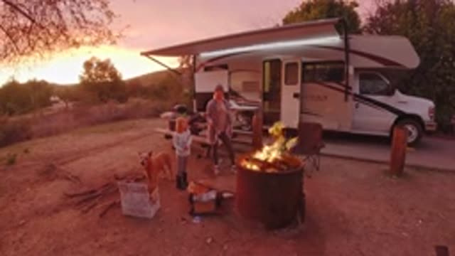 SAN CLEMENTE CALIFORNIA-2019: Dog Fire Child Smoke Woman Camping Woods Chair