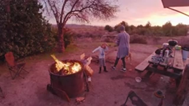 SAN CLEMENTE CALIFORNIA-2019: Mom And Daughter Standing At A Campfire In The Woods