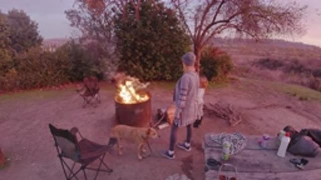 SAN CLEMENTE CALIFORNIA-2019: Mom And Daughter Standing By A Campfire In The Wilderness