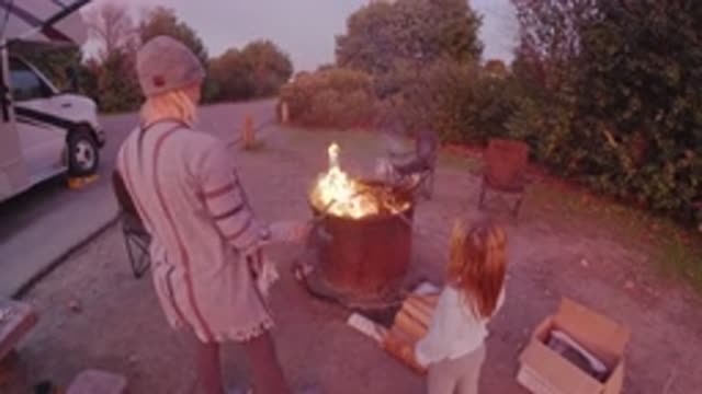 SAN CLEMENTE CALIFORNIA-2019: A Woman and Child Enjoying Evening by Fire Pit