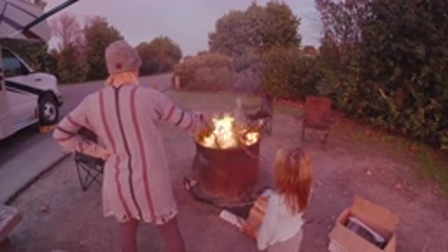 SAN CLEMENTE CALIFORNIA-2019: Mother And Child Roadside Bonfire While Waiting