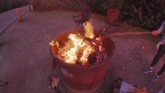 SAN CLEMENTE CALIFORNIA-2019: One Person Makes The Campfire In The Barrels Of