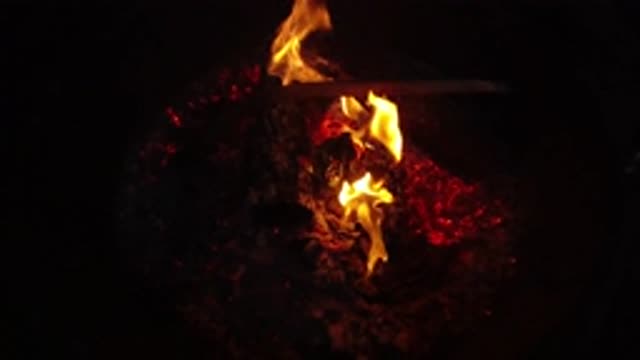 SAN CLEMENTE CALIFORNIA-2019: Logs Burning At Night With Couple
