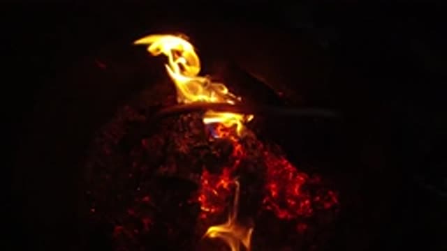 SAN CLEMENTE CALIFORNIA-2019: Orange Flames And Red Embers In Dark Grey Fire Pit