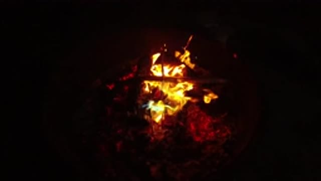 SAN CLEMENTE CALIFORNIA-2019: Controlled Fire in Container with Red Flames and Glowing Sticks