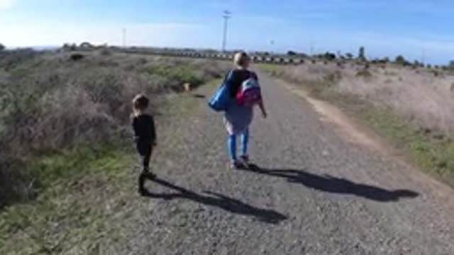 SAN CLEMENTE CALIFORNIA-2019: Mother And Daughter Seen Walking Their Dog Along A Gravel Pathway