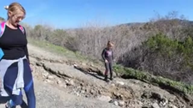 SAN CLEMENTE CALIFORNIA-2019: Two People Are Walking Down A Mountainside With