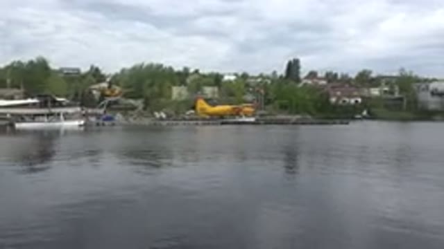 RED LAKE CANADA-2015: Body Of Water With Seaplanes Tied Up At Docks In Distance