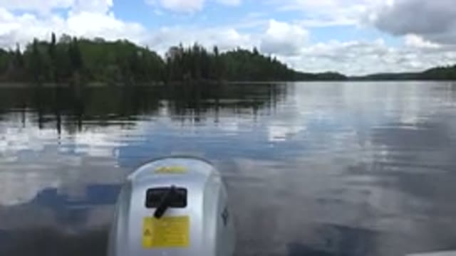 RED LAKE CANADA-2015: White Clouds Blue Sky And Green Tree Reflection In Lake