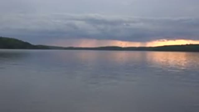 RED LAKE CANADA-2015: Lake With Mountains Clouds And Sunset In The Background