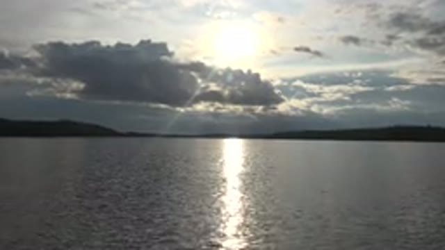 RED LAKE CANADA-2015: Sun High In Sky Over Body Of Water Surface Of Water