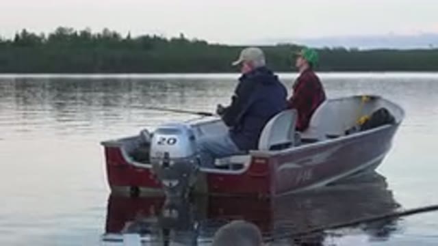 RED LAKE CANADA-2015: Father And Son Fishing In A Beautiful Lake Sitting On The Boat