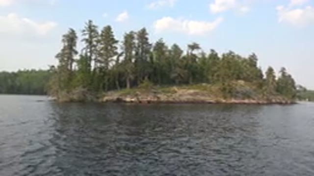 RED LAKE CANADA-2015: Lake With Choppy Water With An Island Full Of Trees Beside