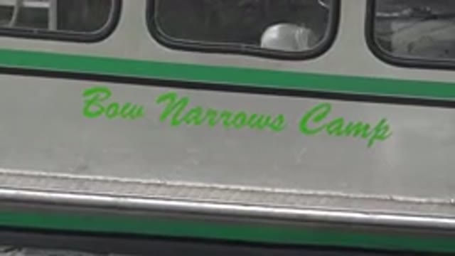 RED LAKE CANADA-2015: Green And White Boat Docked Under Wooden White Structure