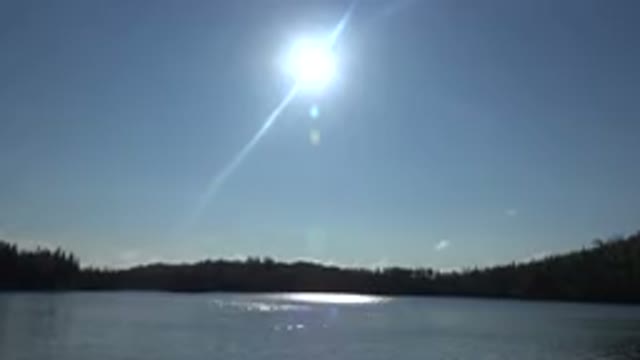 RED LAKE CANADA-2015: Bright Sunlit Day with Water and Trees in Foreground