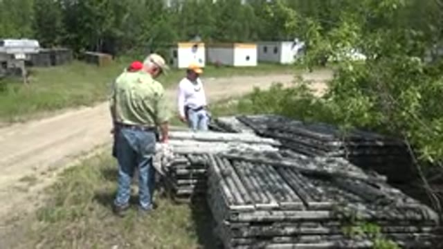 RED LAKE CANADA-2015: Three Men At An Outdoor Backyard Looking At Some Metallic Structures