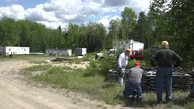 RED LAKE CANADA-2015: People Analyze On Wooden Boards In Sunny Countryside