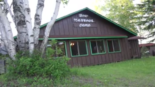 RED LAKE CANADA-2015: A Wooden House Painted Brown With Green Details Surrounded