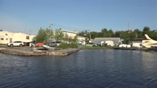 RED LAKE CANADA-2015: View From Water At Sea Plane At Dock Buildings And Cars