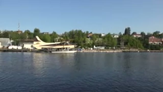 RED LAKE CANADA-2015: A Seaplane Lands on Calm Waters of the Lake