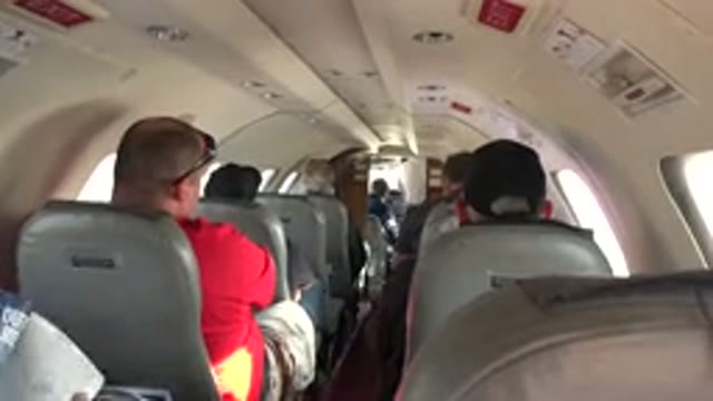 RED LAKE CANADA-2015: View Inside Airplane Of Passengers In Seats In Aisles Up