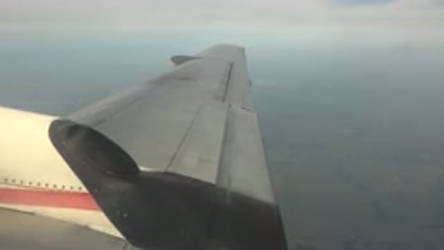 RED LAKE CANADA-2015: An Airplane Wing As the Plane Flies Over a Foggy Landscape