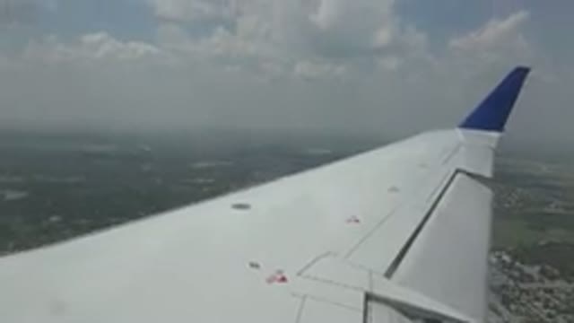 WINNIPEG CANADA-2015: View From Airplane Window Of Wing And Ground Buildings