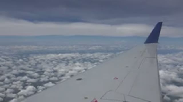WINNIPEG CANADA-2015: The Wing of the Plane Flying Above the Clouds So