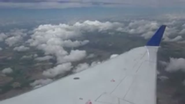 WINNIPEG CANADA-2015: A View From The Side Of A Plane Of Clouds And Land