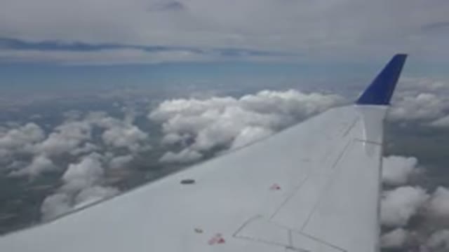 WINNIPEG CANADA-2015: Plane Above The Clouds Filmed From Inside Through The Window
