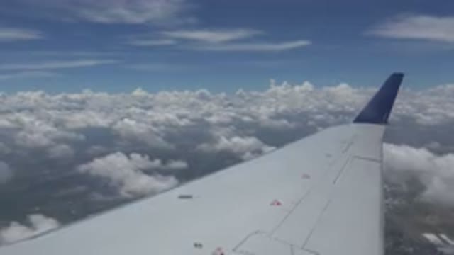 WINNIPEG CANADA-2015: View From Airplane Window Of Wing Ground And Clouds Below